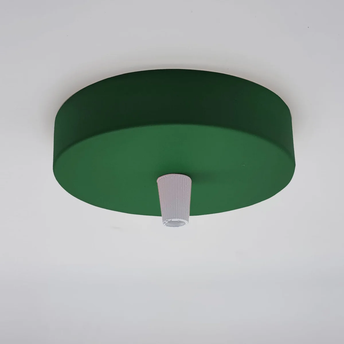 Set of five green vintage industrial pendant ceiling fittings with round metal ceiling roses and cord grips on white background