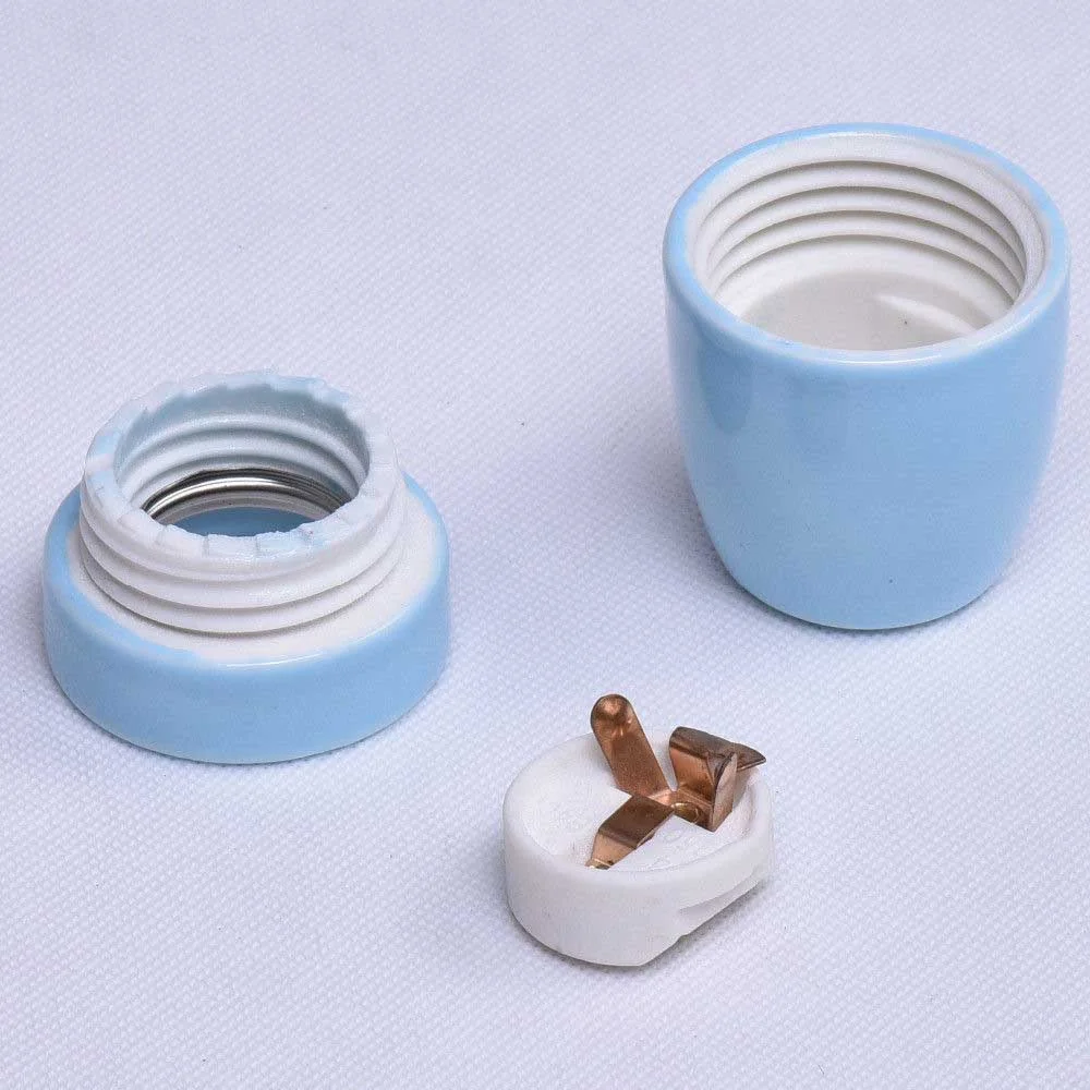 Blue vintage E27 porcelain retro lamp fitting with industrial design and exposed bulb holder on white background