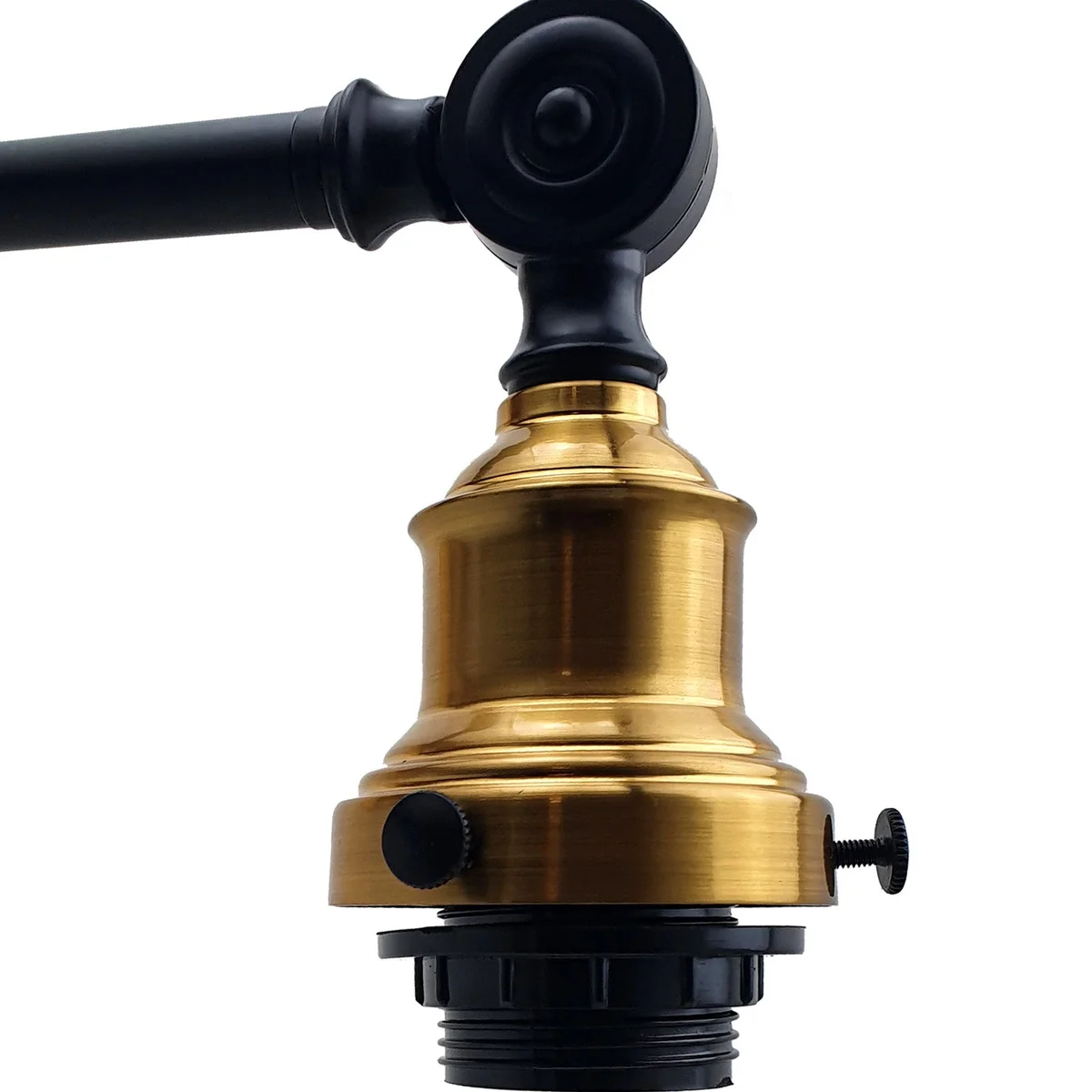 Vintage wall lamp with amber glass shade and metal fittings, casting warm light on a wall.