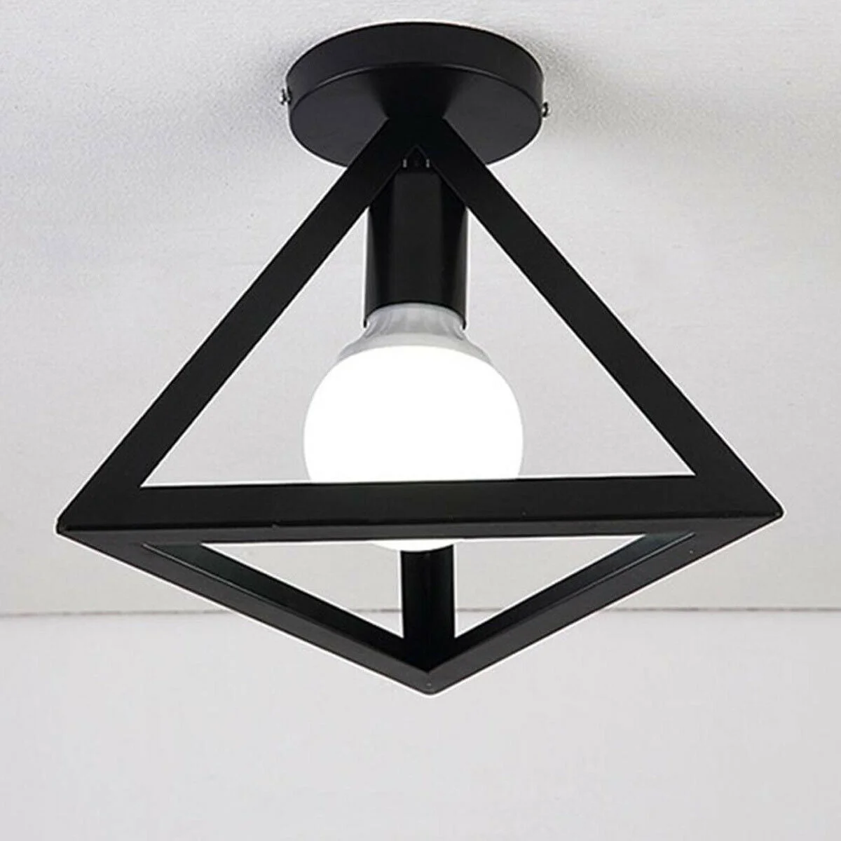 Black geometric cage flush mount ceiling lamp with retro industrial style, a vintage loft ceiling light for modern homes
