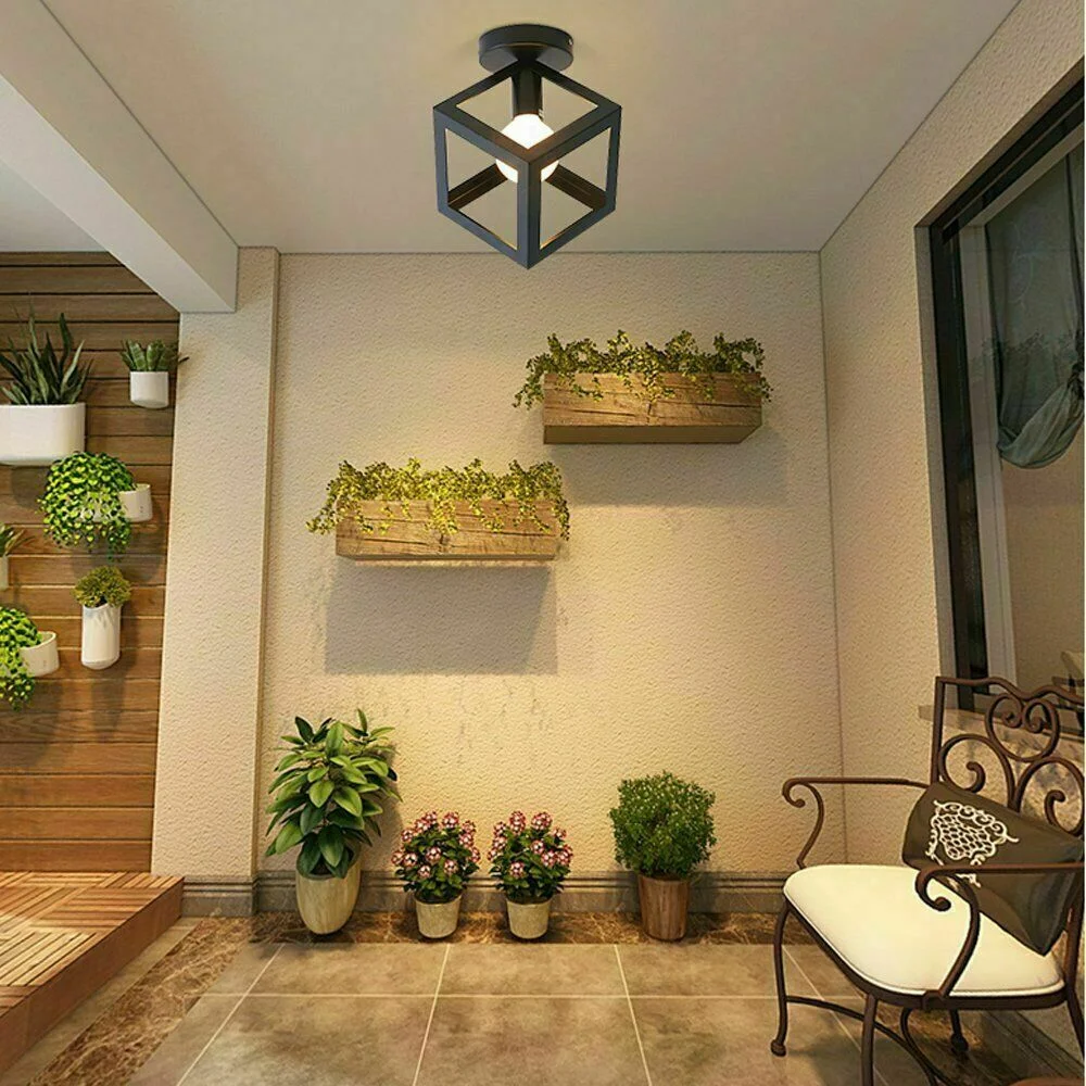 Black metal pendant lampshade with triangle wire cage, ceiling hanging, retro industrial design.