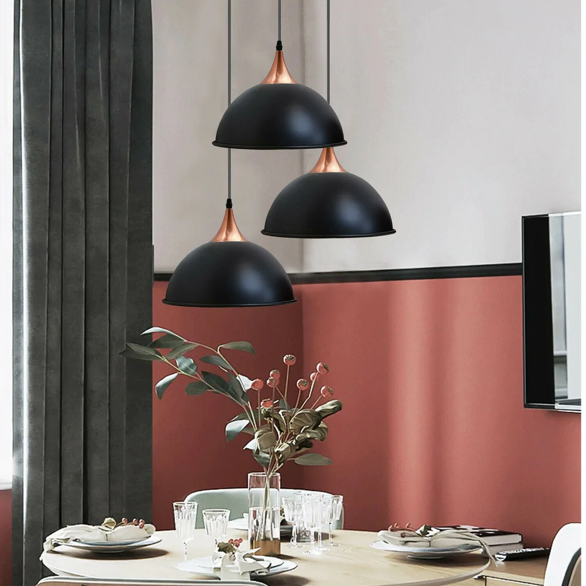Three black pendant lights with frosted glass shades hanging from a PVC cable, mounted on a metal base.