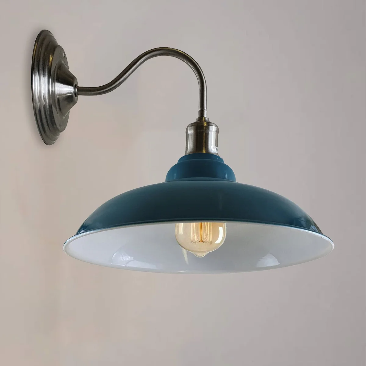 Blue modern industrial wall light with matte metal bowl and white interior hood, hanging on a wall, warm lighting
