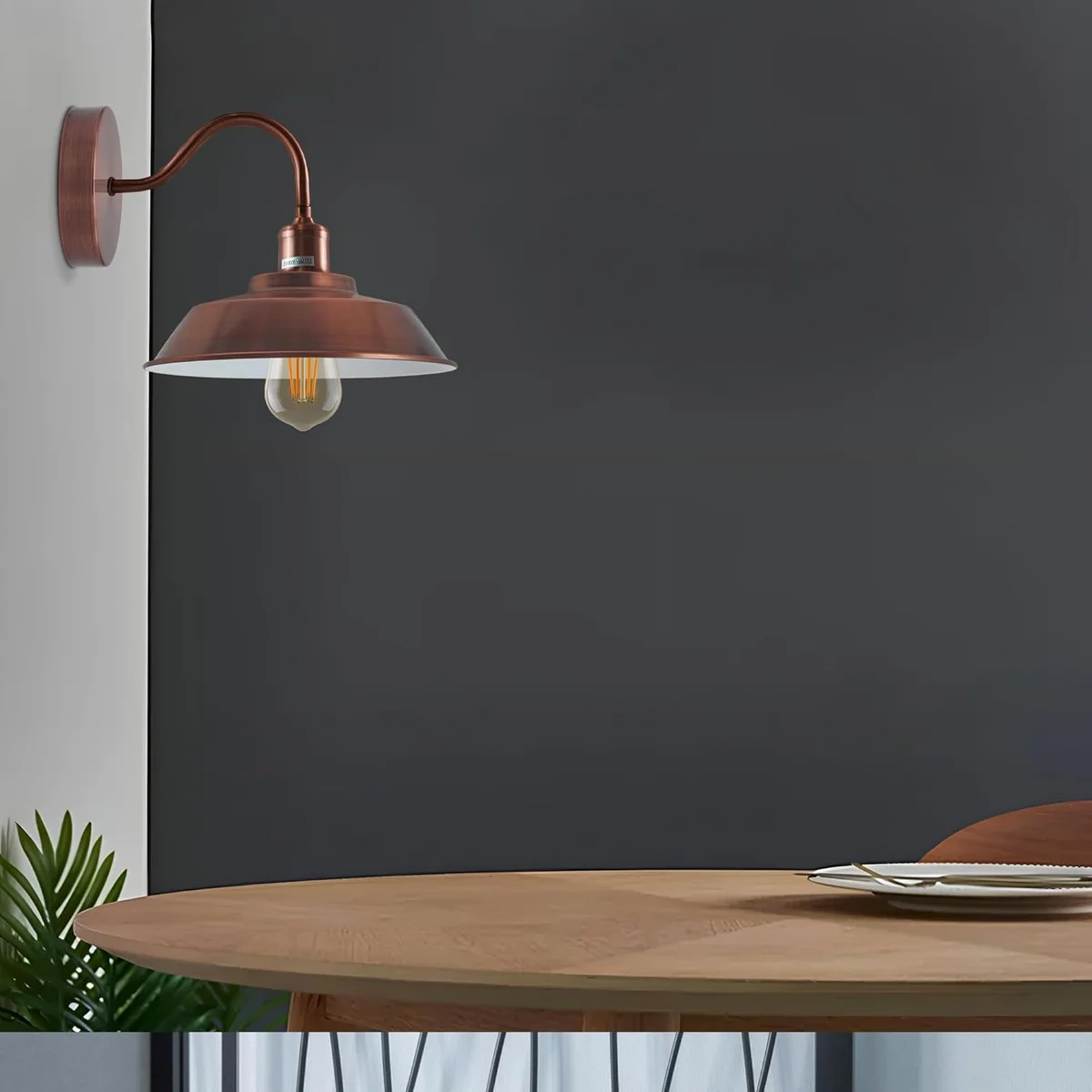 Copper modern wall light with matte finish, white interior bowl, E27 base, hanging from wall.