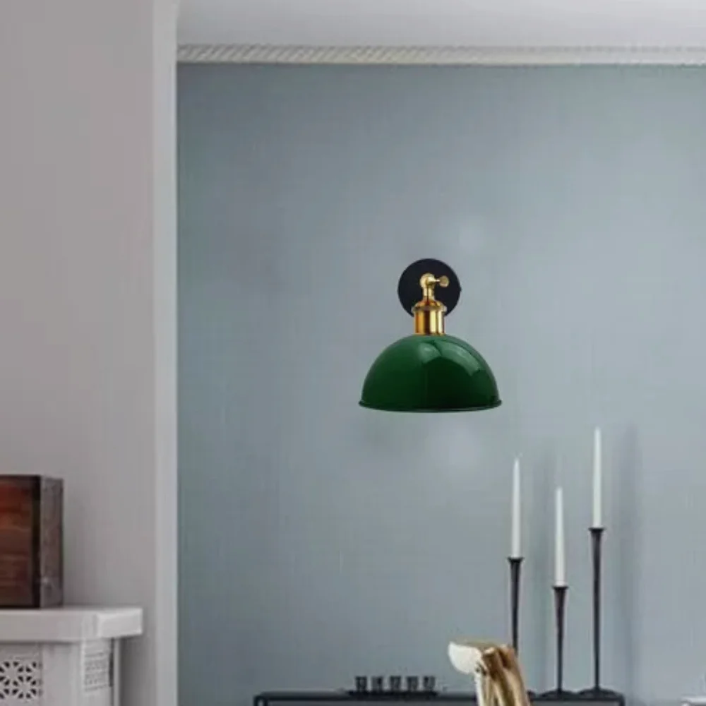 Living room wall light with green dome shade, thick metal cage and lamp holder arm, suited for home décor