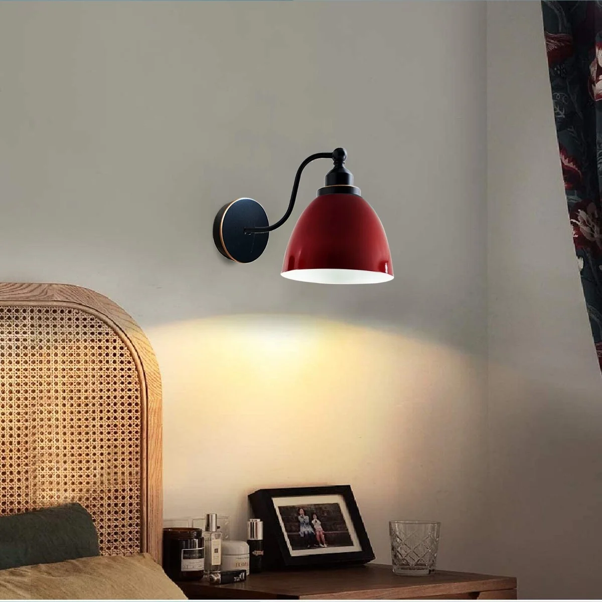 Modern industrial wall light with sleek metal arm and adjustable lampshade, mounted on a wall in a minimalist setting.