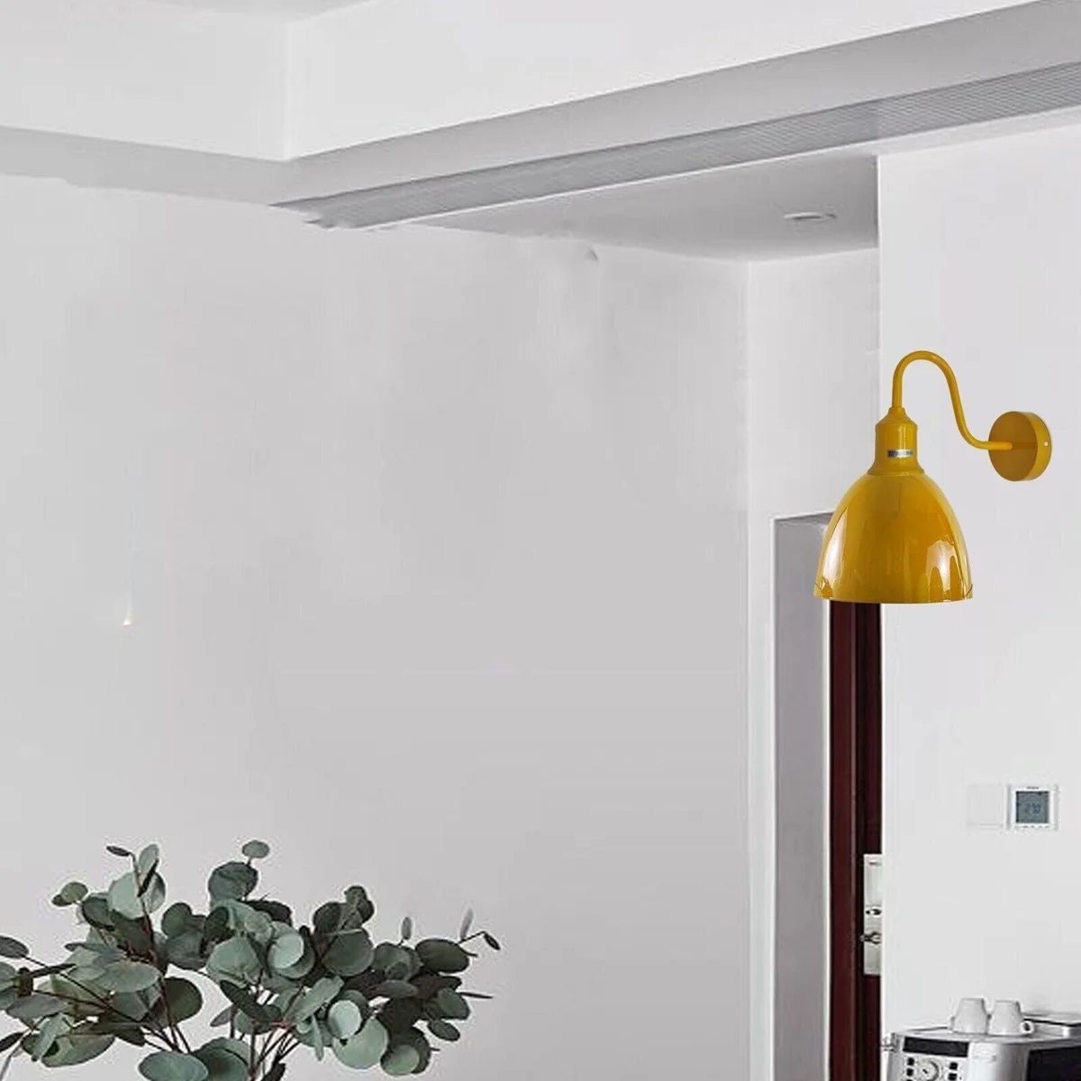 Industrial style wall light with metal body, oval black shade, E27 base, hanging from wall, modern vintage design