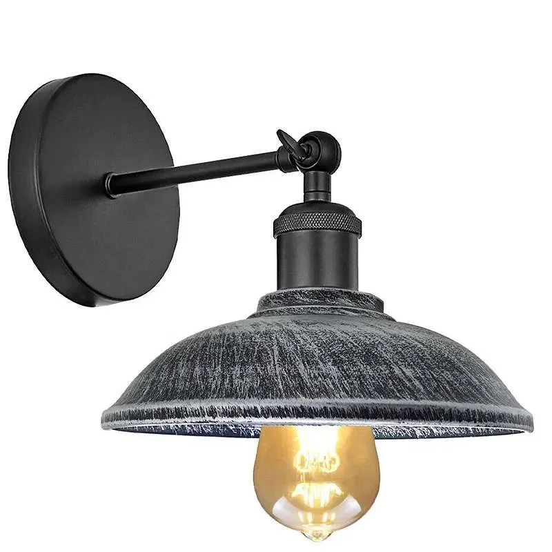 Adjustable metal wall light with umbrella shade, black finish, mounted on wall, vintage industrial style.