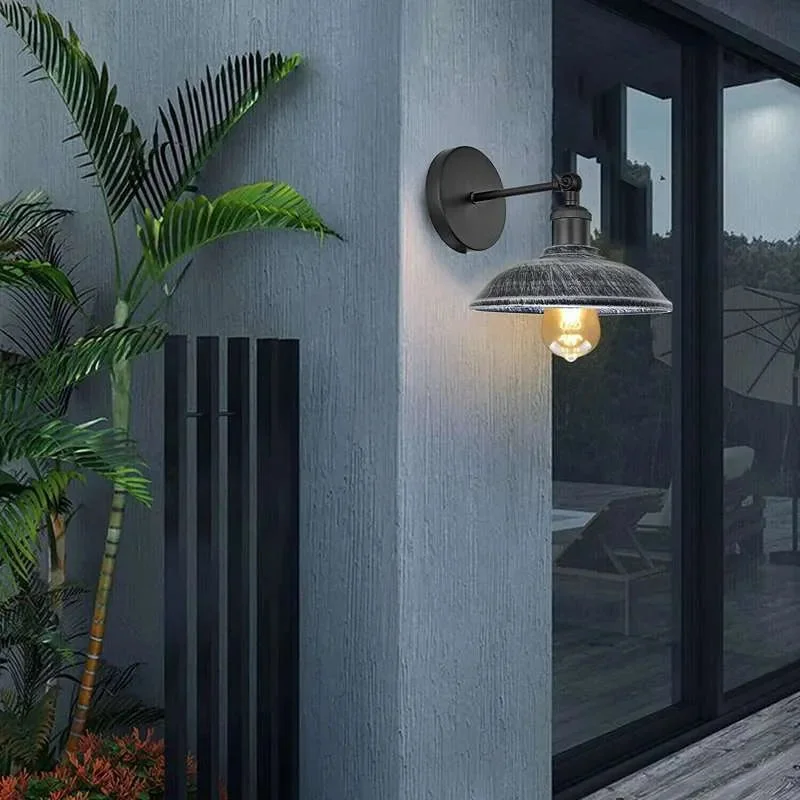 Rustic metal wall sconce with umbrella shade, adjustable arm, in black or brushed copper, depicts modern vintage lighting