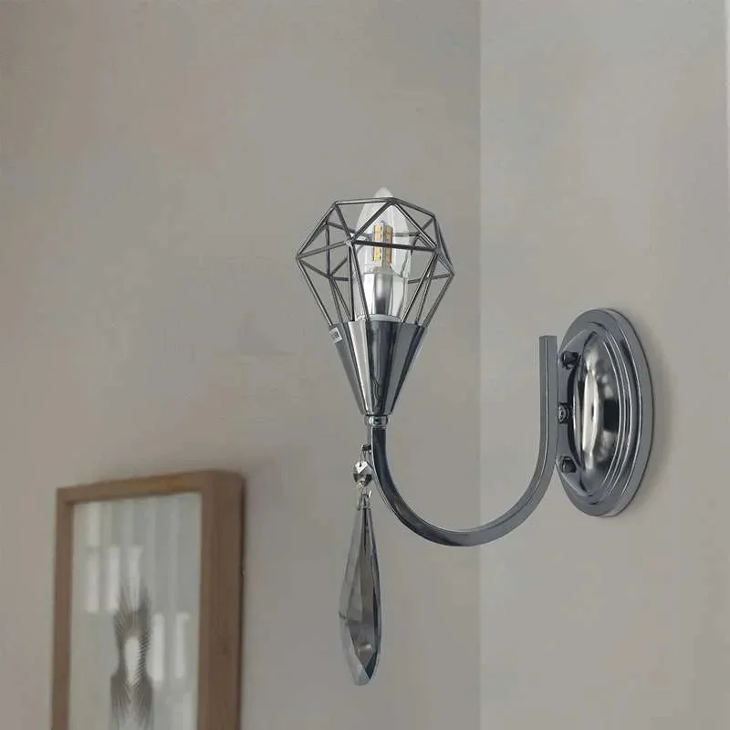 Curved arm wall light in chrome metal with a crystal droplet and single candelabra bulb