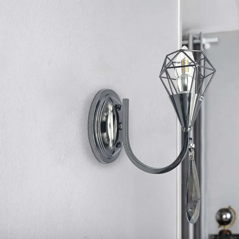 Curved arm wall light in chrome with a single crystal droplet, a sleek modern fixture for entryway or living room.