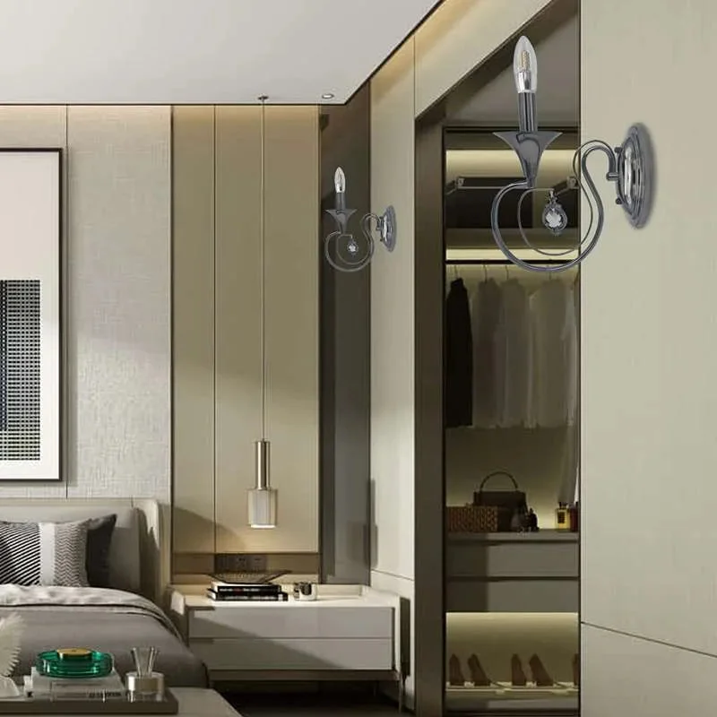 Polished chrome indoor wall lighting fixture with curved arm for a single candelabra light