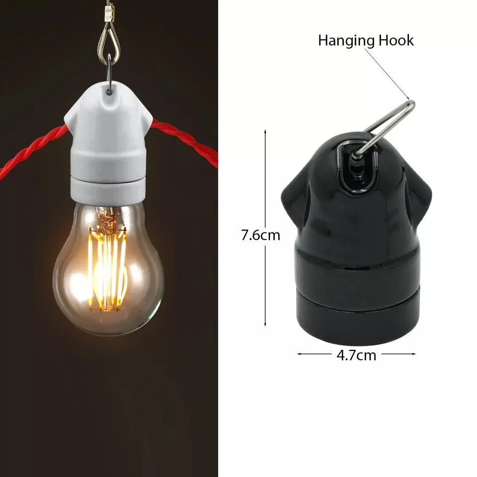 Metal lamp holder with exposed filament bulb, vintage industrial style, black metal E27 socket, sleek accented fixture.
