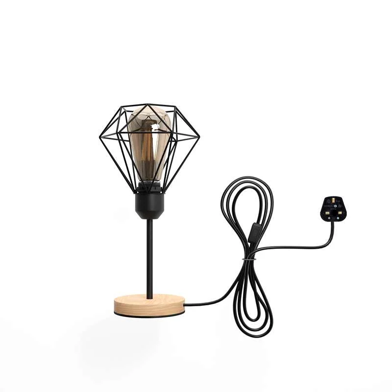 Vintage black metal cage lamp with natural wood base, featuring a diamond-shaped cage shade and a power cable.