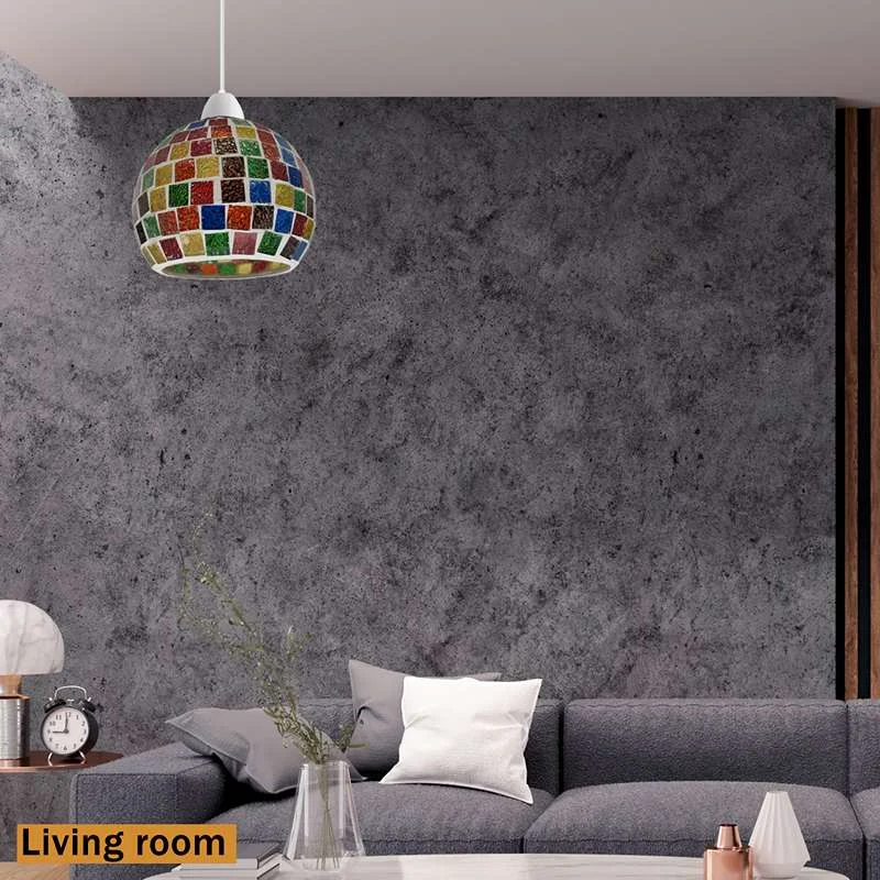 Globular mosaic table lamp with multicoloured glass faces and beads, hanging from a simple base on a table.