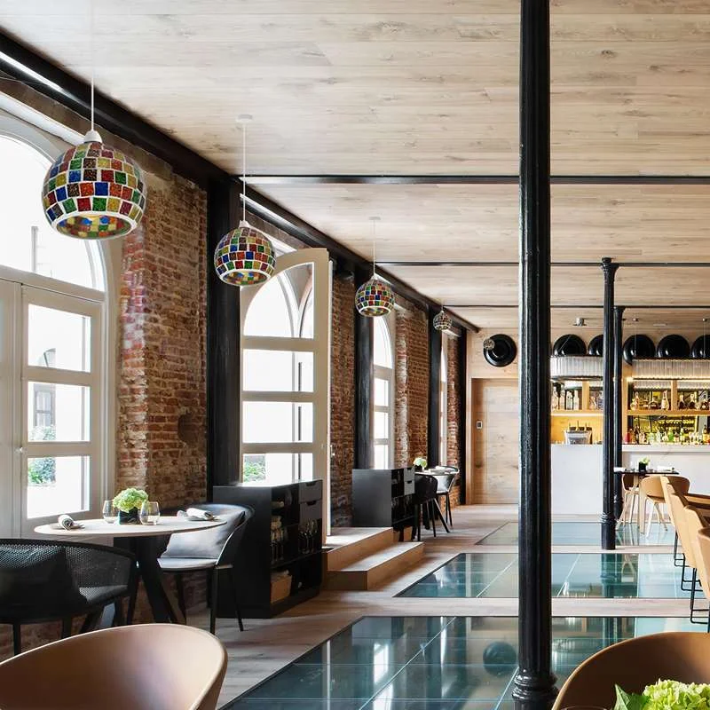 Multi‑coloured mosaic glass globe‑shaped indoor decorative lamp on a small table with hand‑cut glass beads.