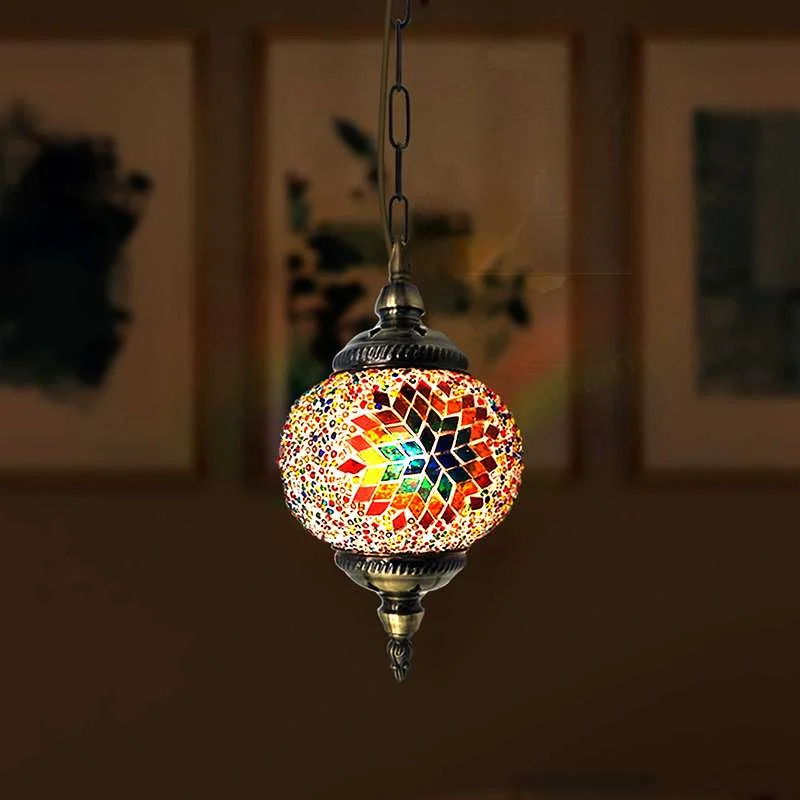 Hand‑cut Turkish mosaic pendant light with 14 cm multicolour glass globe hanging on ornate antique brass chain.