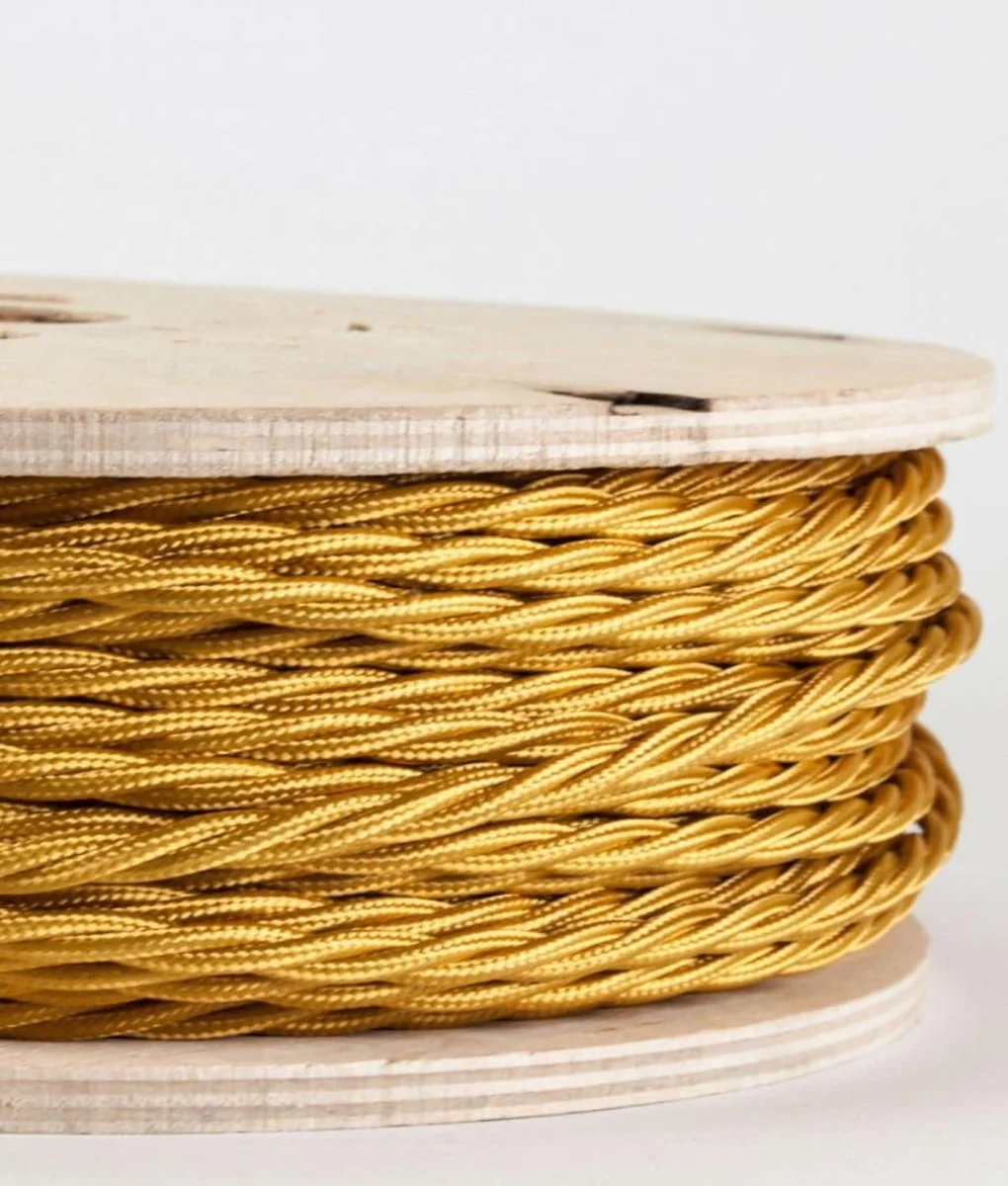 Gold twisted cable with soft fabric finish, 3 core, 6 mm diameter, a 1 m length spooled against a plain background.
