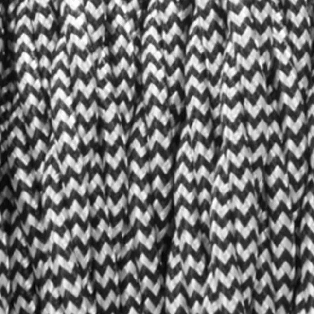 Black and white 3 core fabric cable in a twisted, 5‑meter spool, showing yellow PVC inner core and braided outer.