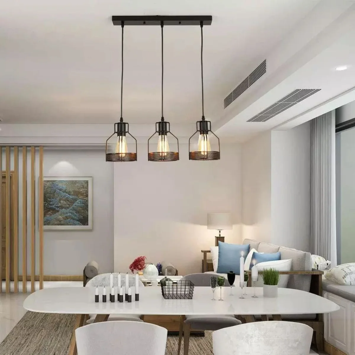 Black pendant light with three diamond cage shades, metal wire frame, hanging from ceiling with PVC cables.