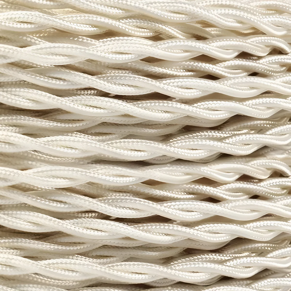 Twisted ivory fabric cable displaying the 2 core fabric cable with braided strands and a neutral ivory finish.