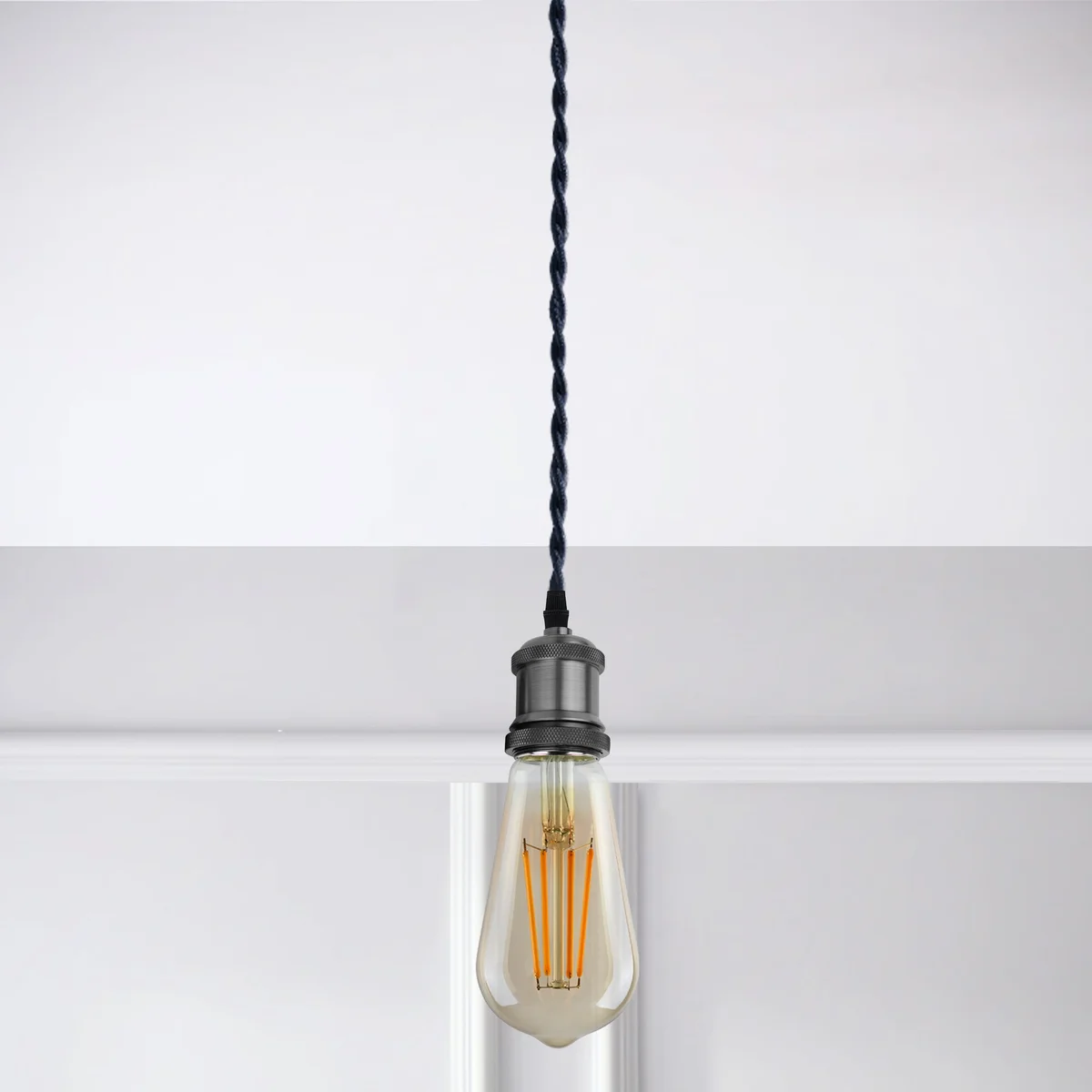 Vintage twisted lighting cable in neutral ivory, showing its flexible 2‑core fabric construction wrapped around a lamp base