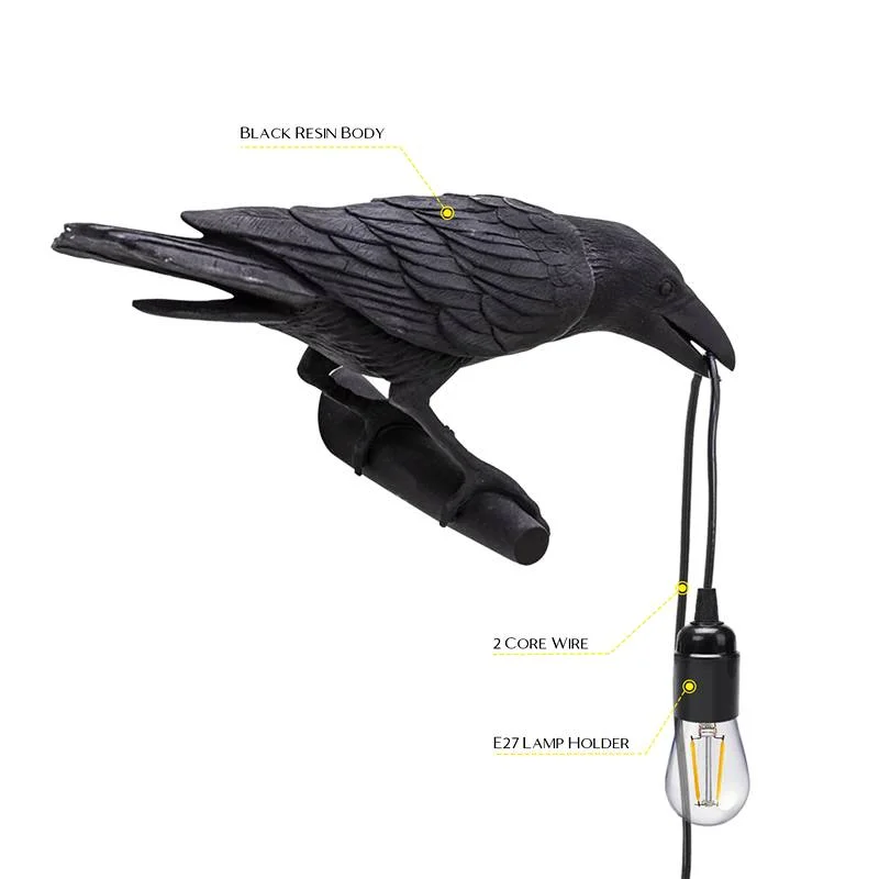 Sleek black resin crow lamp with detailed carving and glossy finish, showing a lifelike crow pointing downward – wall‑mounted.