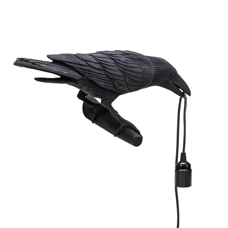 Black resin crow lamp on wall, detailed black resin crow design with LED light, modern art deco style.