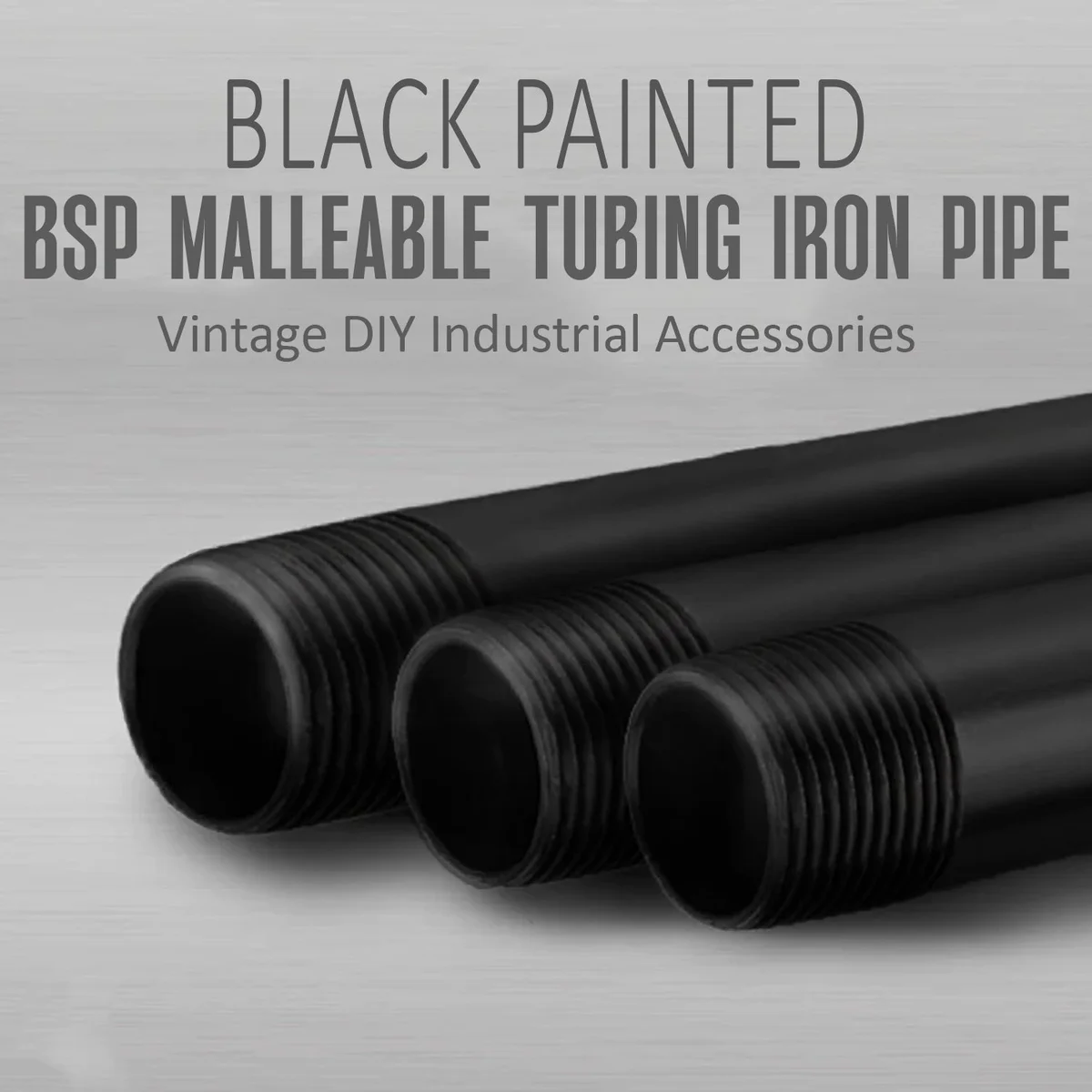 Black 2.5cm iron male-to-male pipe fitting with BSP threading, shown in close‑up on a workbench