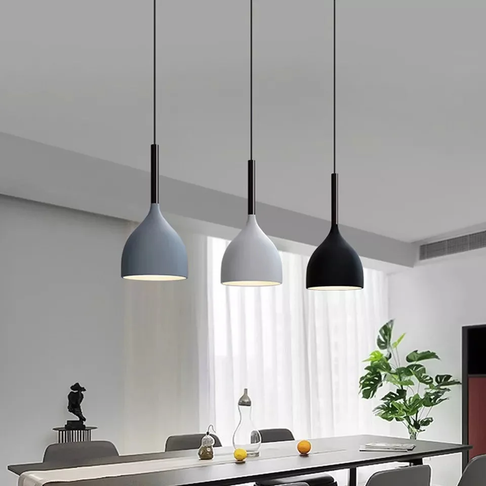 Modern 3 way pendant light with metal cutouts and black, white and gray shades, adjustable 95cm cables, hanging from ceiling.