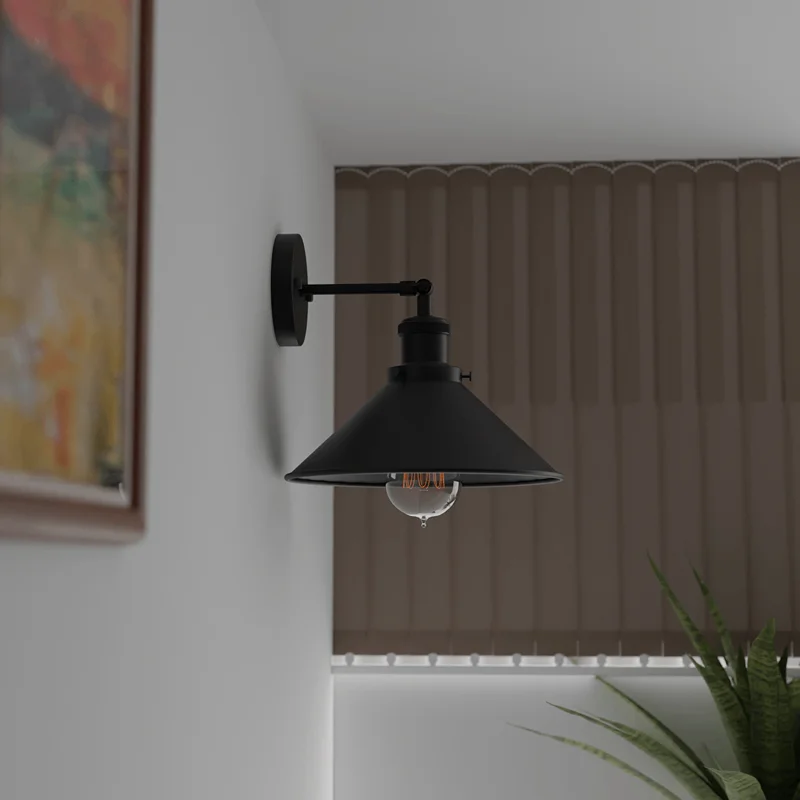 Black vintage industrial style wall light with adjustable metal arm and rectangular lamp shade hanging on a wall.