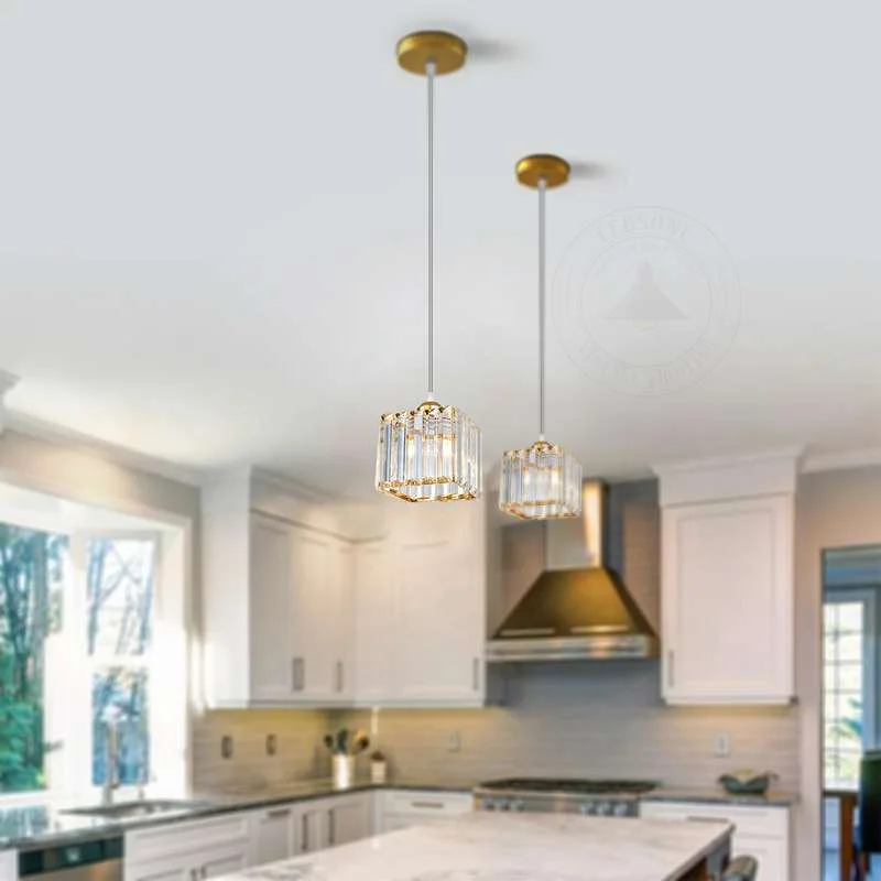 Square crystal pendant light with faceted glass and polished chrome frame, hanging from ceiling
