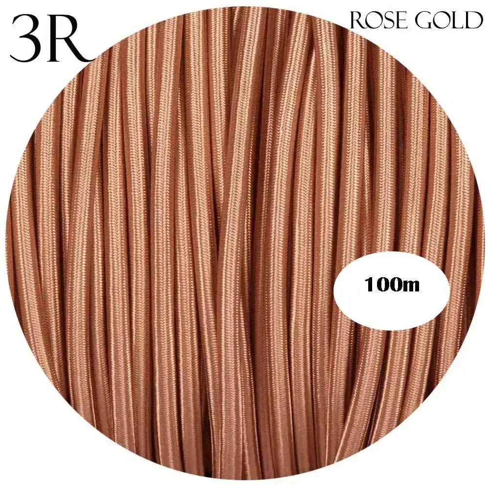 Rose gold 3‑core cable, double insulated, covered in braided fabric, seen laid out on a flat surface.