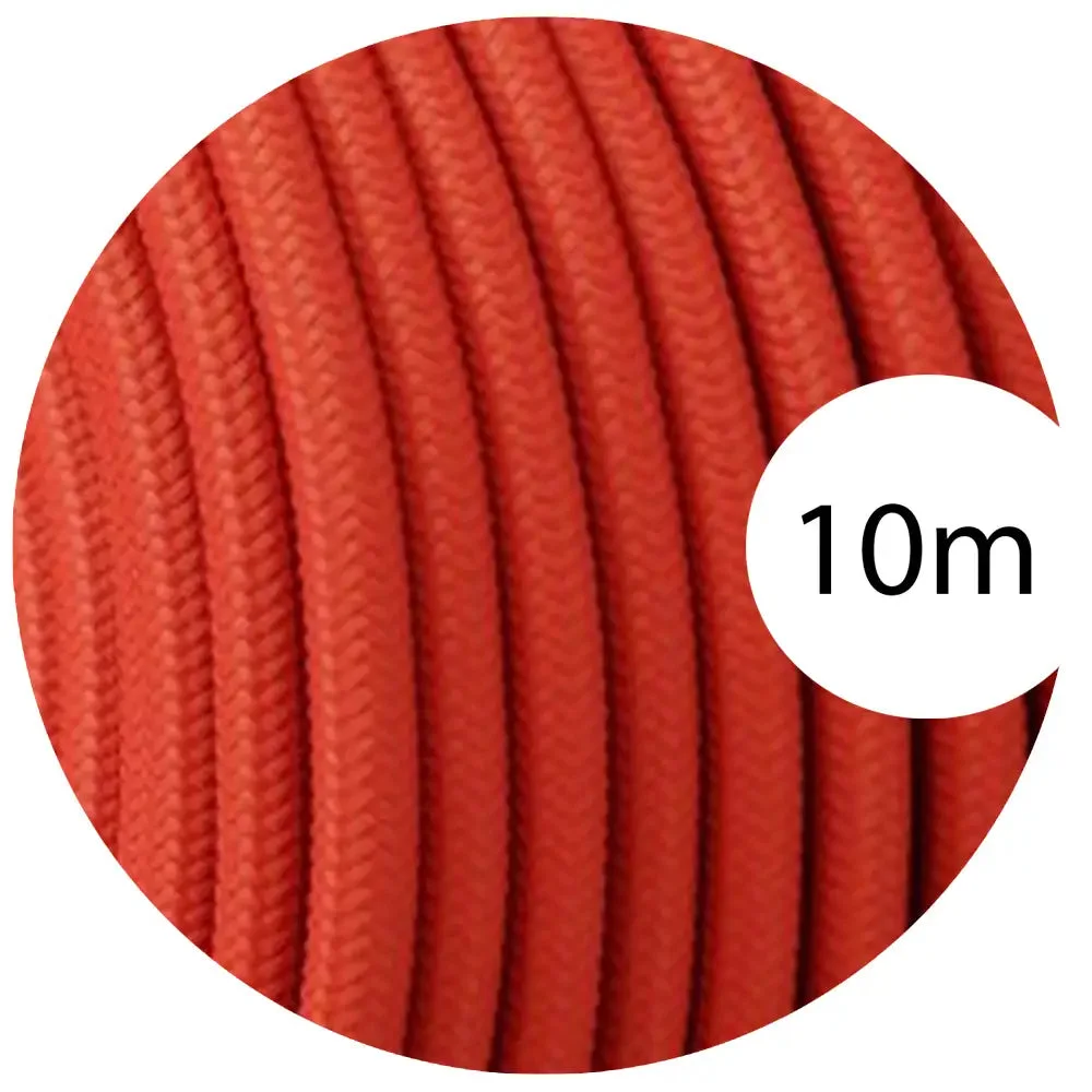 Peach‑toned vintage fabric cable showing bright round braid, three cores, and black PVC jacket.