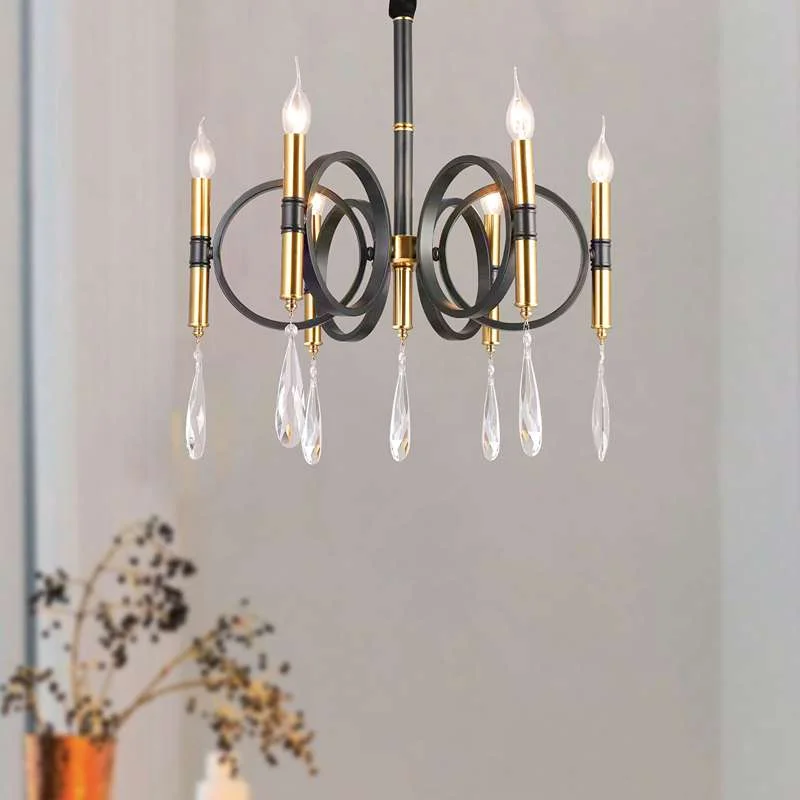 Gold chandelier kitchen island fixture with six crystal lights and candle‑style metal arms on an iron frame