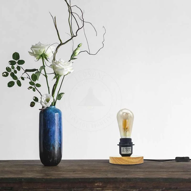 Adjustable cable lamp with black metal holder, natural wood base, on/off switch, suitable for bedside night light.