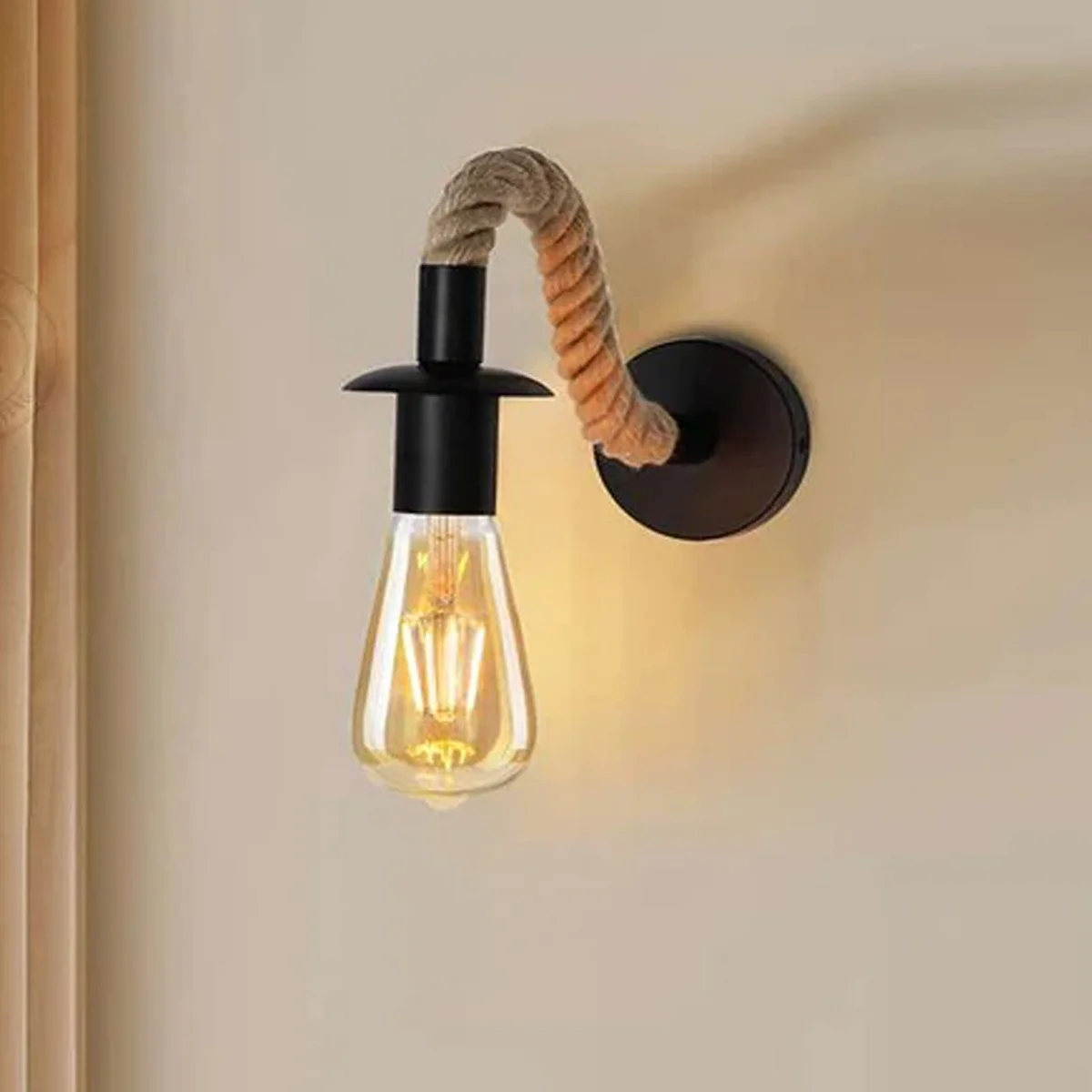 Vintage hemp rope wall light with 180° adjustable metal arm and sleek black E27 socket hanging on a bedroom wall