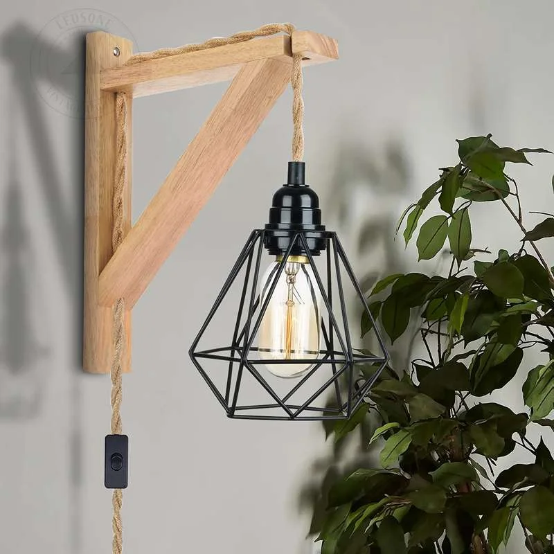 Hanging retro wall lamp featuring a black metal diamond cage, wooden base, long hemp rope cord
