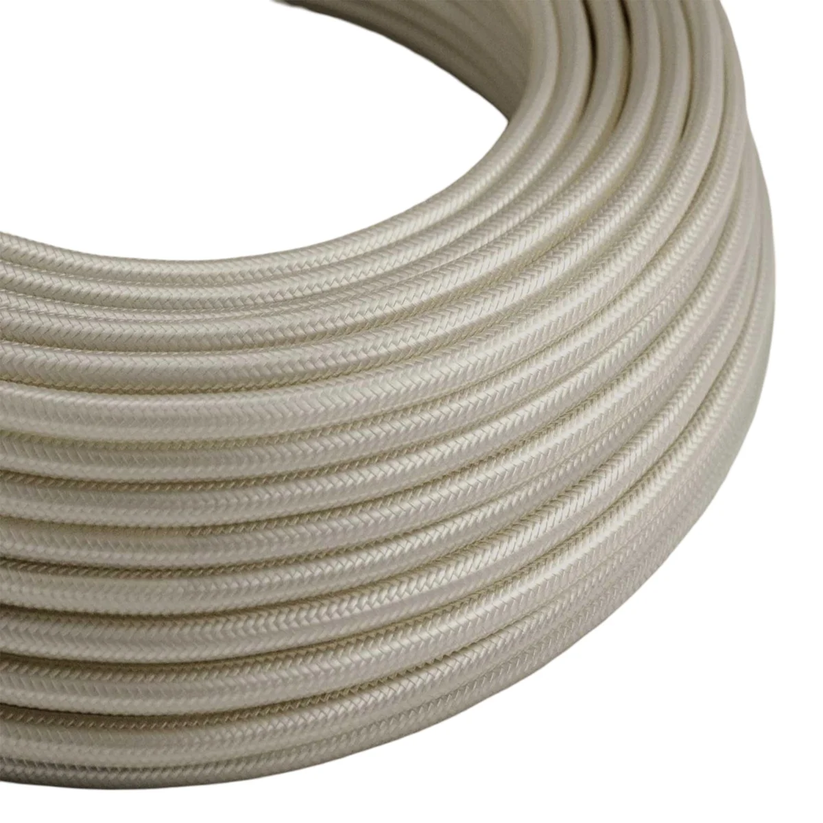 Cream braided fabric cable, round 7mm diameter, 3-core, 0.75mm copper, shown on a continuous roll.
