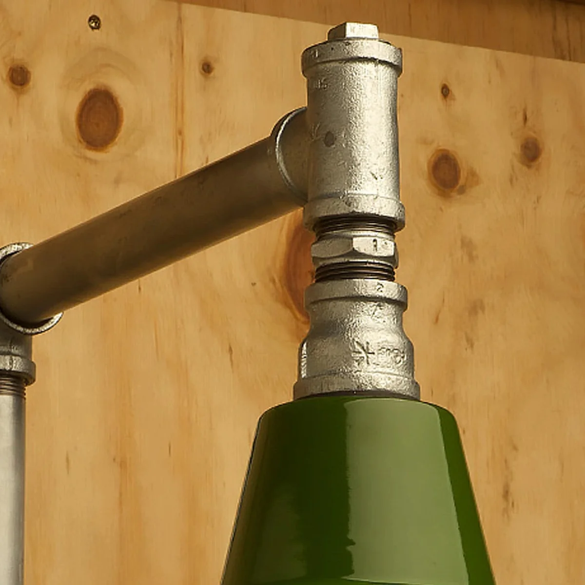 Galvanized malleable iron nipple pipe light fitting displayed on metal table, suitable for DIY pipe light fittings