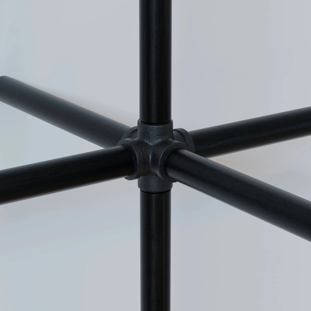 Black painted malleable iron pipe fitting, 3/4" BSP threads, ideal for custom industrial lighting or steampunk furniture.