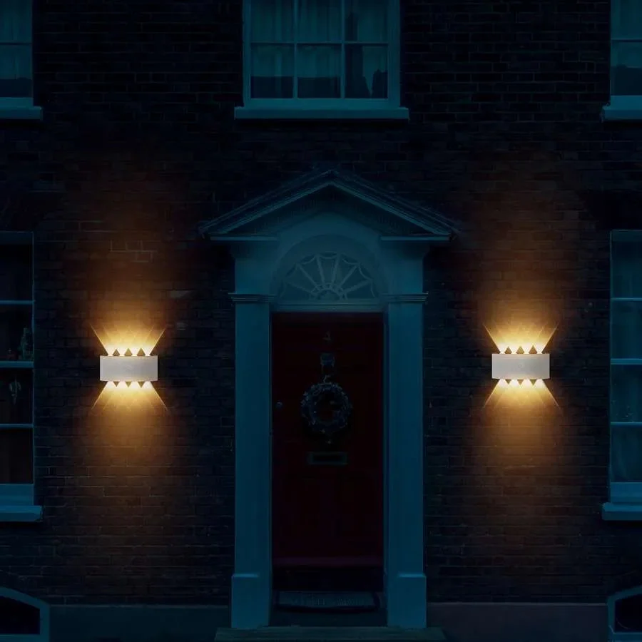 White rectangular motion‑activated outdoor LED wall lights in die‑cast aluminum, warm white glow.