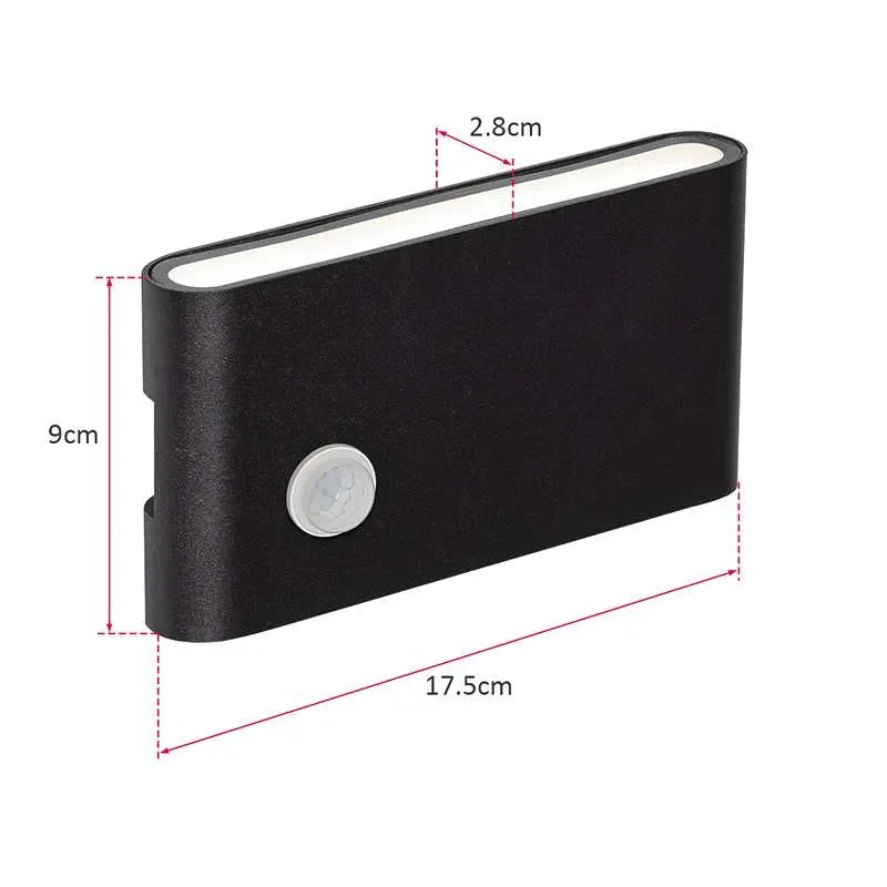 Dual‑head outdoor wall light in white and black, casting warm white glow, with motion sensor inset.