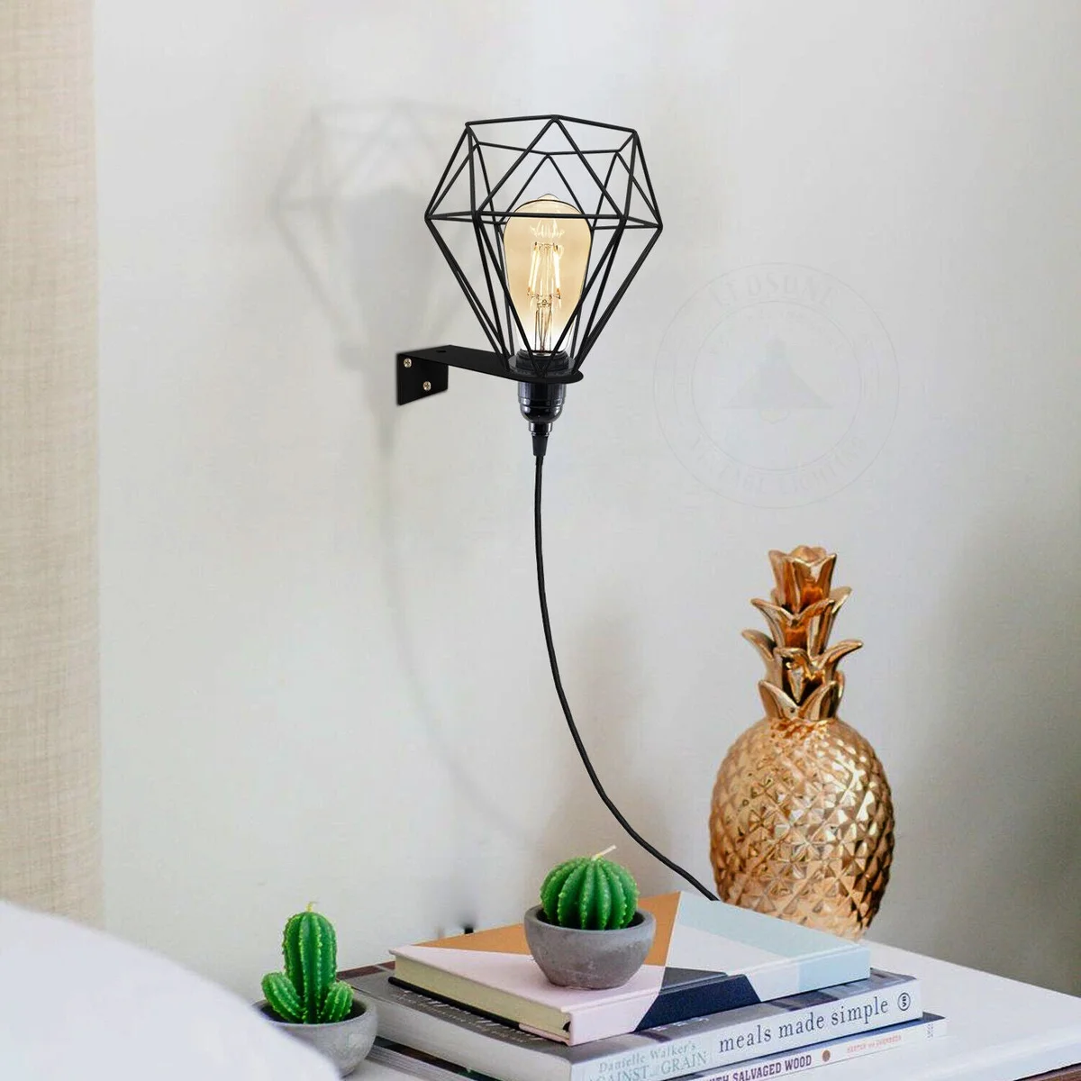 Metal cage wall light with diamond cage design, plug‑in, hanging on living room wall