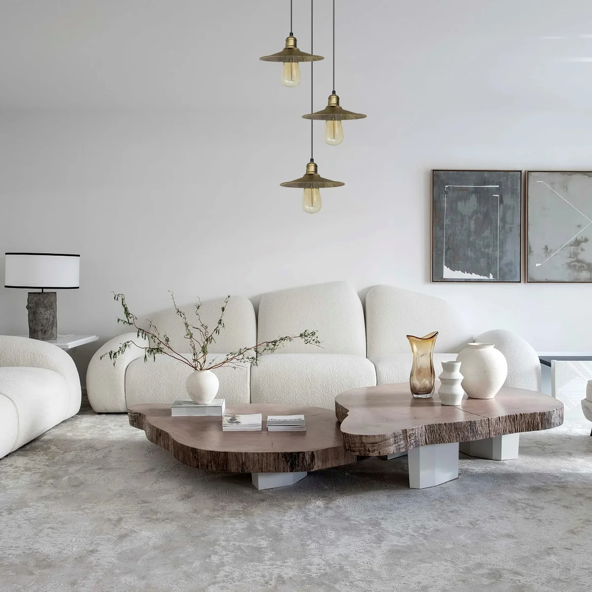 Antique brass pendant light with three flat white shades hanging from ceiling, vintage brushed metal finish.