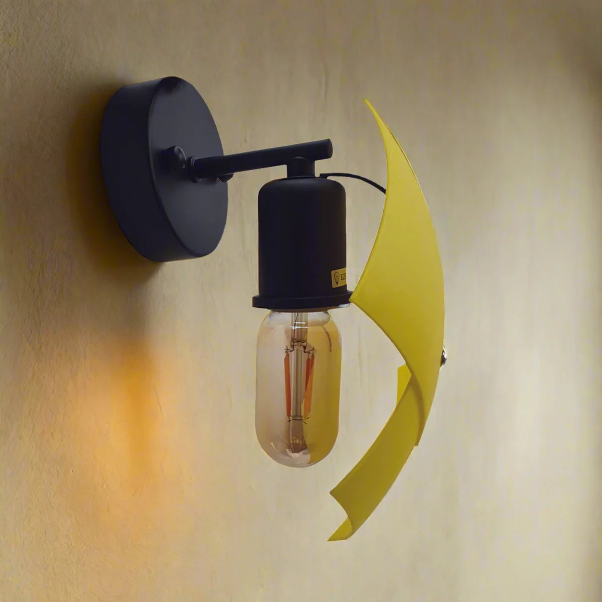 Yellow indoor wall sconce, curved PVC shade, metal body, wall-mounted, two units.