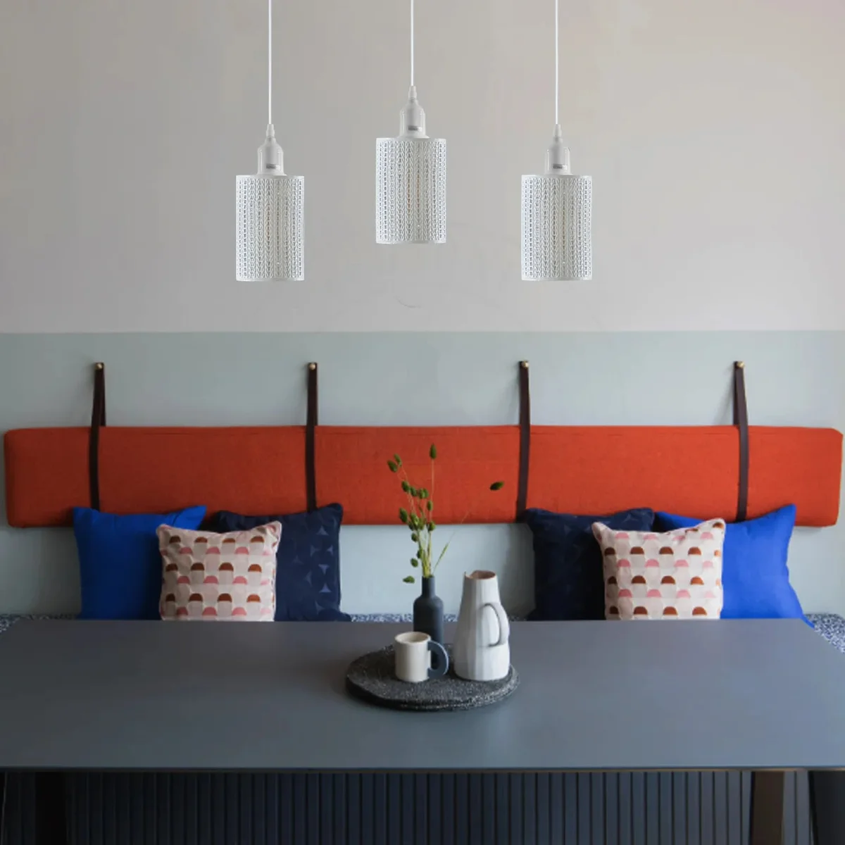 3‑light adjustable metal cage light with black metal frame and cage‑style shades, hanging from indoor wall.