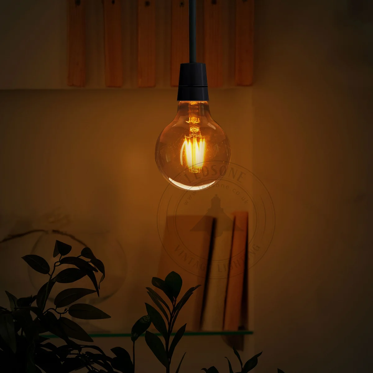 Three amber G95 LED filament bulbs (E27) with visible filaments, vintage aesthetic, energy efficient LED bulb.