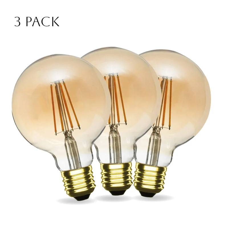 Stack of three vintage amber G95 LED filament bulbs with visible filament, 4W E27 fittings, warm white LED bulb glow