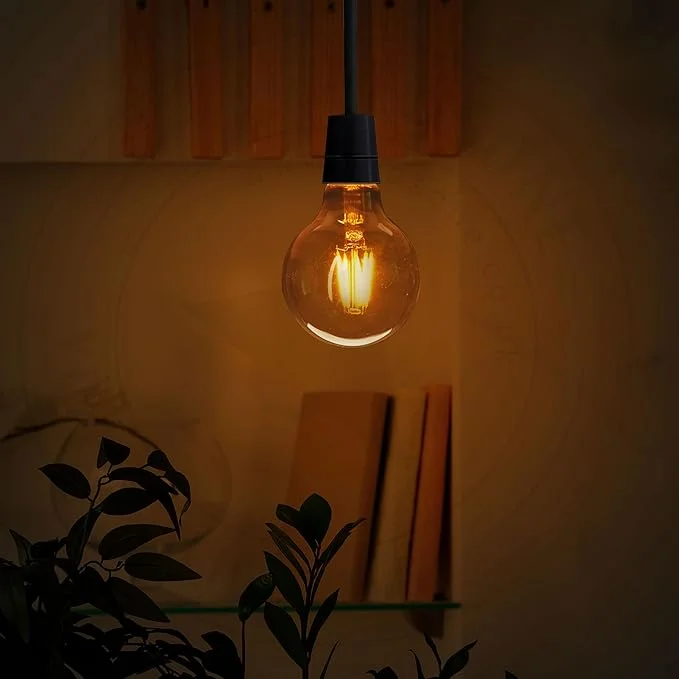 B22 LED bulb in classic amber globe shape with warm amber tint, metal base, vintage style.